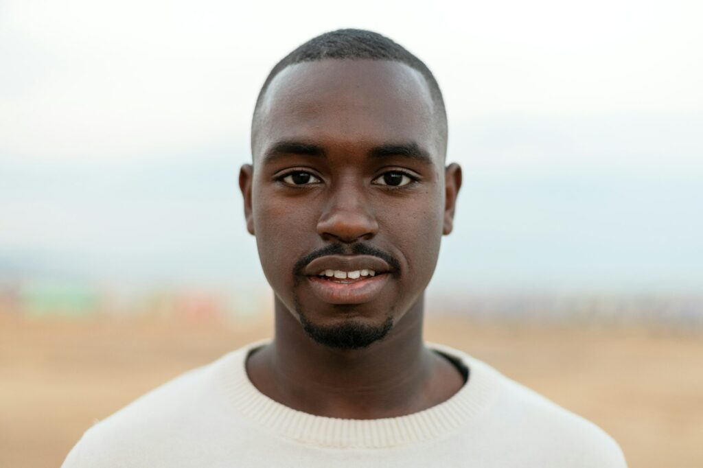 Portrait of young African American man looking at camera. Headshot.