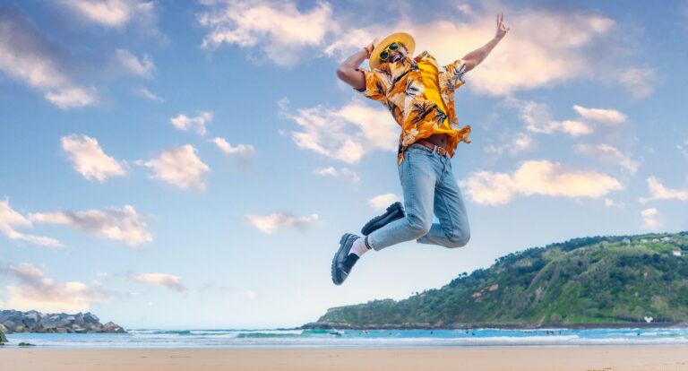 African man jumping celebrating holidays on the beach