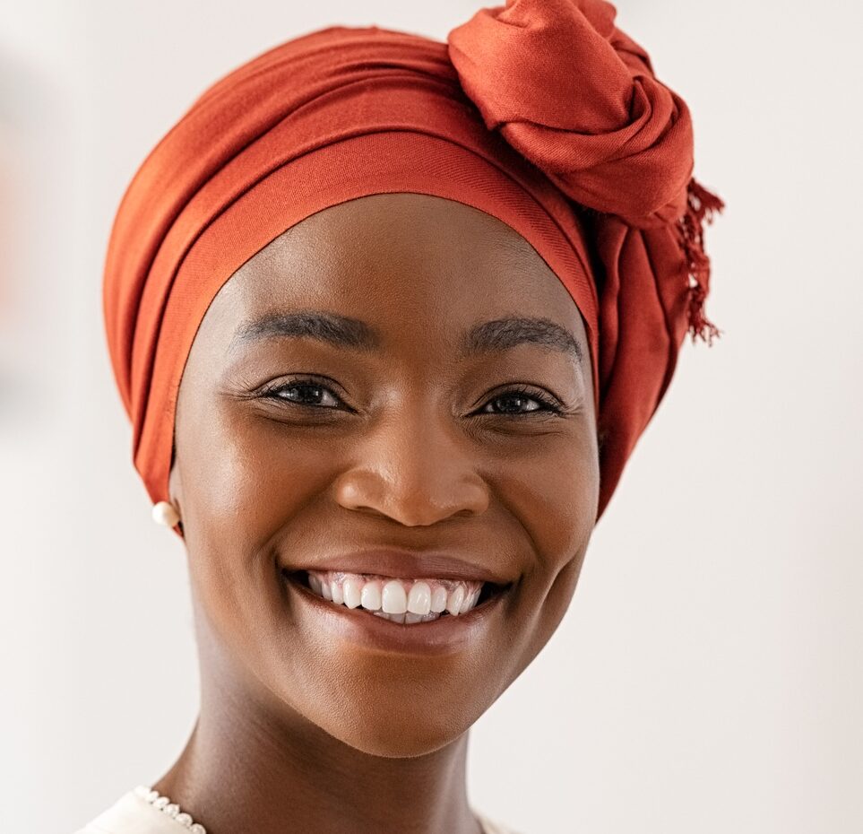 Smiling mature black woman with african headscarf